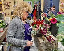 Several designers, making gorgeous arrangements behind the scenes